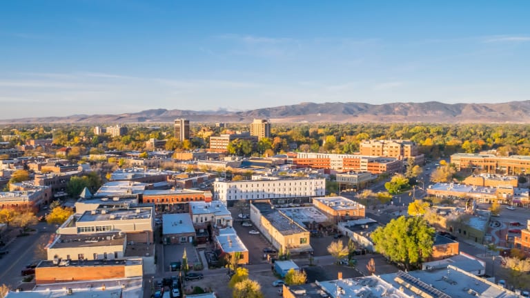 Aerial view of Old Town Fort Collins with the Front Range in the distance